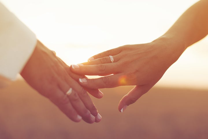 wedding couple holding hands on ...