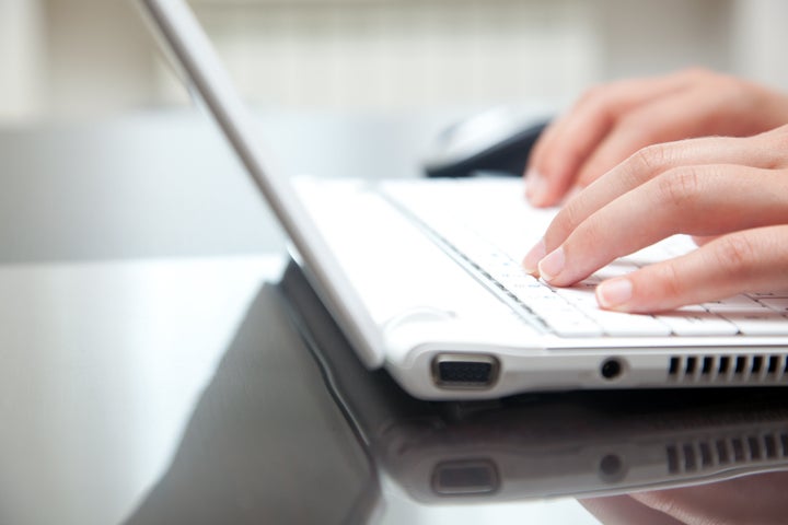 female hands typing on a laptop