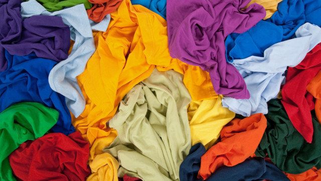 Lots of bright messy colorful clothing, abstract background.