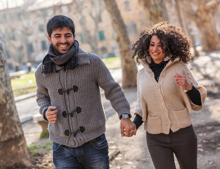 young couple running in the city