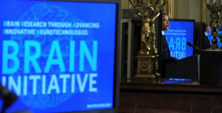 US President Barack Obama is reflected on a mirror as he speaks on the Brain Research through Advancing Innovative Neurotechnologies (BRAIN) Initiative on April 2, 2013 in the East Room of the White House in Washington, DC. Launched with approximately $100 million in the President?s Fiscal Year 2014 Budget, the BRAIN Initiative ultimately aims to help researchers find new ways to treat, cure, and even prevent brain disorders. AFP PHOTO/Jewel Samad (Photo credit should read JEWEL SAMAD/AFP/Getty Images)