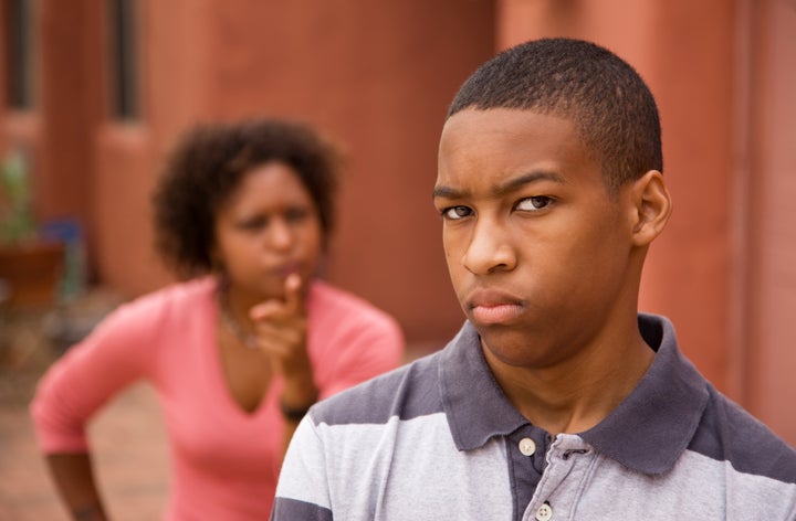 Upset teen and mother outside of house