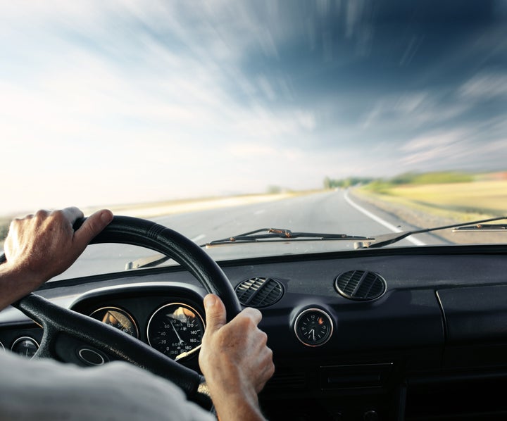 driver's hands on a steering...