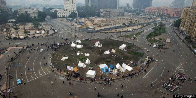 People are seen milling around at Egyptian revolution landmark Tahrir Square in Cairo on November 24, 2012, the day after opposition-led protests were held in most of Egypt's major cities, sparking violent clashes in the canal city of Suez and the Mediterranean city of Alexandria, where offices of the Islamist Freedom and Justice Party, which backed Mohamed Morsi for the presidency, were torched. AFP PHOTOGIANLUIGI GUERCIA (Photo credit should read GIANLUIGI GUERCIA/AFP/Getty Images)