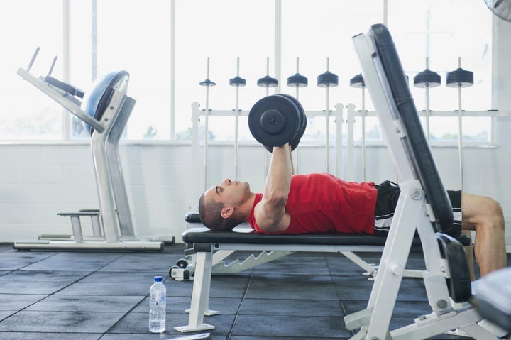 Middle Eastern man exercising in health club