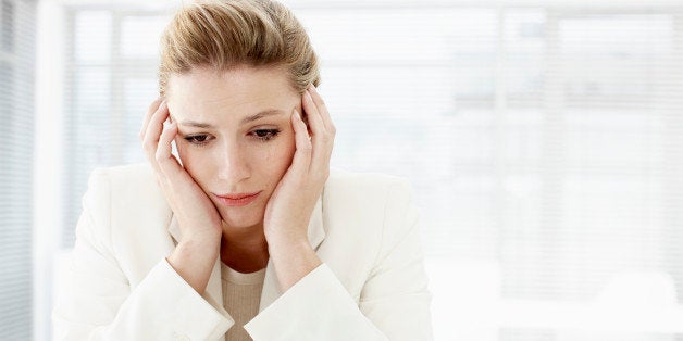 Businesswoman with head in hands