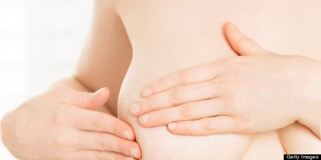 Young woman performing breast cancer self-exam . You might also be interested in these: