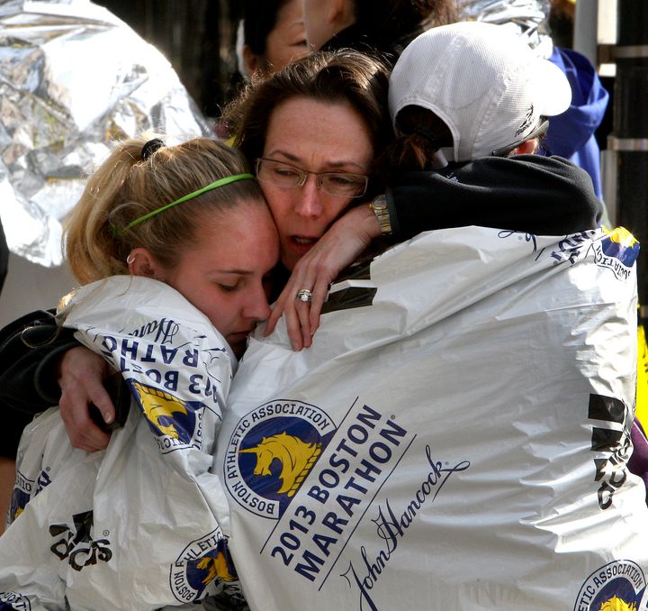 BOSTON - APRIL 15: Katherine Swierk, left, is reunited with her aunt Terry Days, center, and friend Jocelyn Cacio outside Copley Square in Boston after two explosions went off near the finish line of the 117th Boston Marathon on April 15, 2013. Swierk was a race volunteer and Cascio ran the race, dropping out after 25.6 miles. (Photo by John Blanding/The Boston Globe via Getty Images)