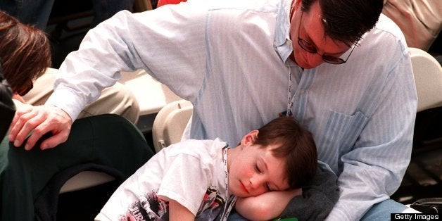 BOSTON - APRIL 19: A boy takes a rest at the finish line of the Boston Marathon. (Photo by Tom Herde/The Boston Globe via Getty Images)