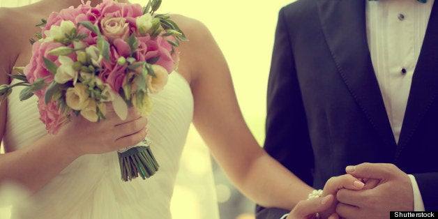 bride and groom holding hands