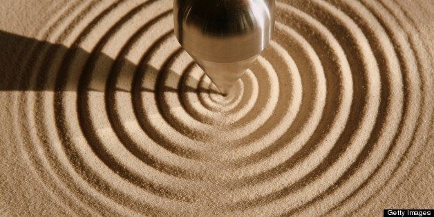 Steel pendulum that forms spiral design in sand.