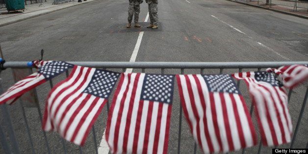 BOSTON, MA - APRIL 16: American flags on a roadblock fly in remembrance of victims of the bombing of the Boston Marathon at a roadblock manned by National Guardsmen at the end of Boylston Street, on April 16, 2013 in Boston, Massachusetts. Two bombs exploded near the finish line of the marathon the day before, killing some and injuring more than 100 people. (Photo by Melanie Stetson Freeman/The Christian Science Monitor via Getty Images) via Getty Images)
