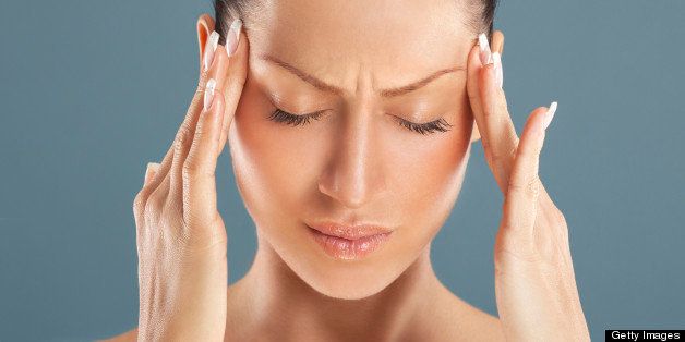 Woman got a headache attack.Head massage.