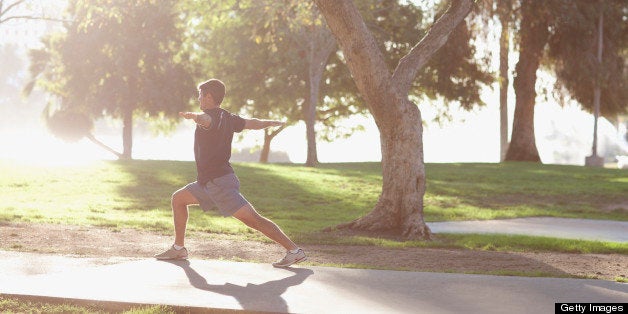 Man practicing yoga in park