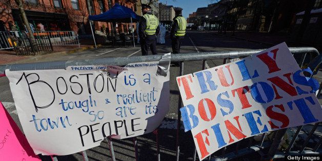 BOSTON, MA - APRIL 21: Signs are placed at a makeshift memorial for victims near the finish line of the Boston Marathon bombings two days after the second suspect was captured on April 21, 2013 in Boston, Massachusetts. A manhunt for Dzhokhar A. Tsarnaev, 19, a suspect in the Boston Marathon bombing ended after he was apprehended on a boat parked on a residential property in Watertown, Massachusetts. His brother Tamerlan Tsarnaev, 26, the other suspect, was shot and killed after a car chase and shootout with police. The bombing, on April 15 at the finish line of the marathon, killed three people and wounded at least 170. (Photo by Kevork Djansezian/Getty Images)