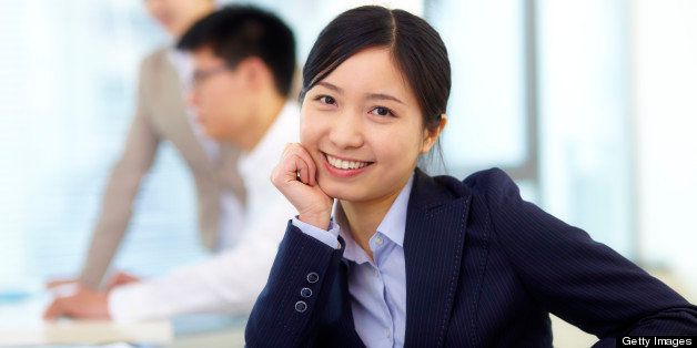 picture of young asian businesswoman looking at camera smile in office