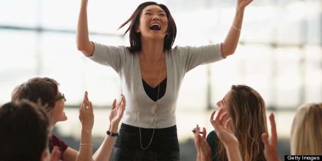 Excited Woman, Arms Raised In Air, During Meeting