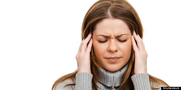 young woman having a headache...