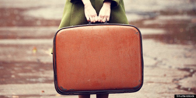 Style redhead girl with suitcase at beautiful autumn alley.