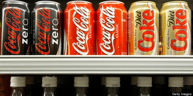 UNITED STATES - FEBRUARY 14: Cans and bottles of Coca-Cola are displayed in a grocery store in New York, Wednesday, Feb. 14, 2007. Coca-Cola Co., the world's largest soft-drink maker, may say profit rose on the second-biggest sales gain in three years as Europeans bought more no-calorie Coca-Cola Zero soda and the company sold more coffee in Japan. (Photo by Adam Rountree/Bloomberg via Getty Images)