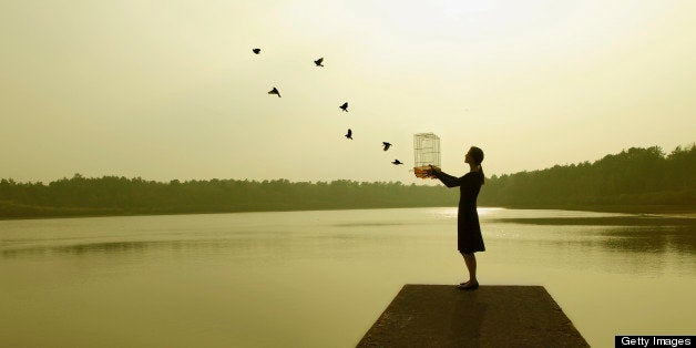 a women releases birds from her cage