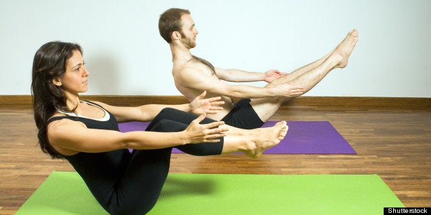 man and woman sitting on yoga...