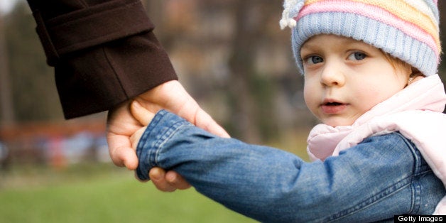 Child holding mother's hand