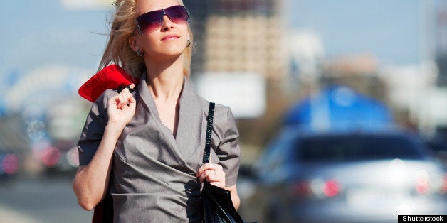 young woman walking on a city...