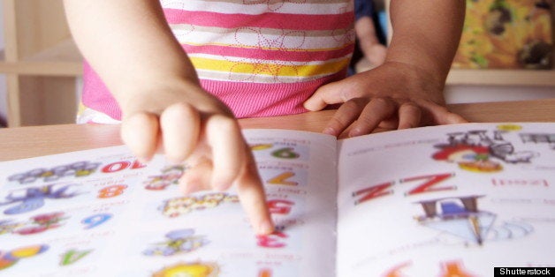 Little Girl Learning Figures and Letters with Picture Book