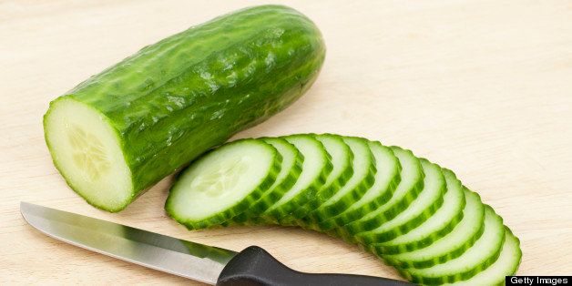 Freshly sliced Cucumber on a wooden chopping board