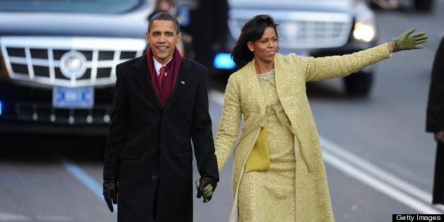 US President Barack Obama and his wife Michelle wave to supporters as they walk along Pennsylvania Ave during the parade following his inauguration as the 44th US president of the United States in Washington, DC on January 20, 2009. AFP PHOTO/ ROBYN BECK (Photo credit should read ROBYN BECK/AFP/Getty Images)