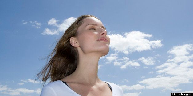 Young woman outdoors with eyes closed
