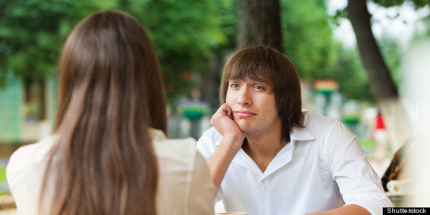 guy is bored on a date with a girl in a summer cafe