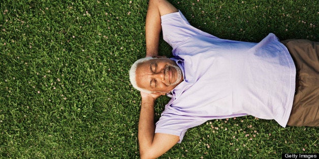 Senior man lying down on grass