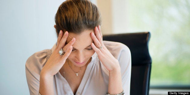 Close-up of a businesswoman suffering from a headache in an office