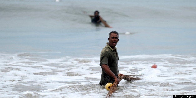 Sri Lankan fishermen pull a fishing net on the beach in the southern Sri Lankan town of Galle on April 12, 2012, a day after residents along the country's coast were asked to move inland following a tsunami alert. Sri Lanka on April 11 lifted the tsunami alert issued after an undersea earthquake in Indonesia had sparked fears of giant waves hitting coasts across the Indian Ocean, the government said. AFP PHOTO / Ishara S. KODIKARA (Photo credit should read Ishara S. KODIKARA/AFP/Getty Images)