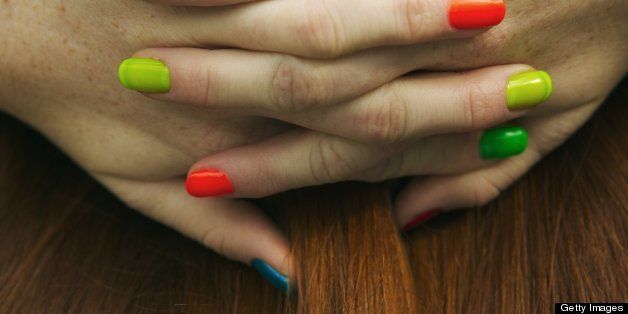 Hands with multicolored nail polish