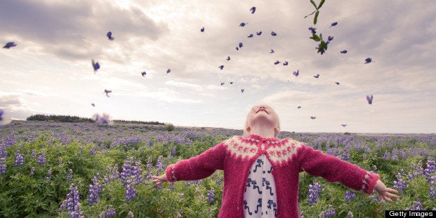 Girl throwing flowers up in air.