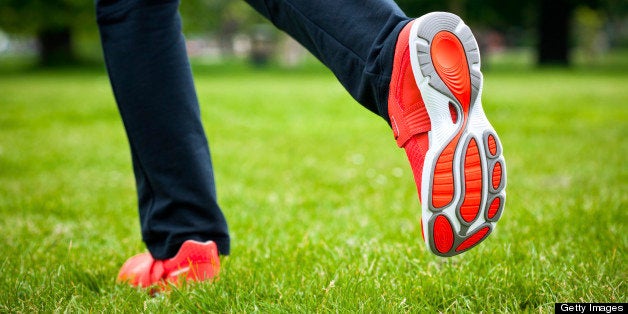 Woman jogging in the park, close up of feet.