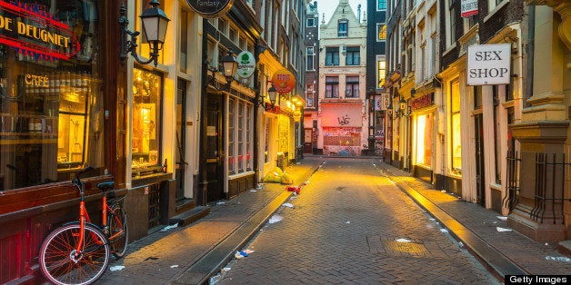 A litter filled Red Light District in the early hours of the morning, De Wallen, Amsterdam, Netherlands, Europe.