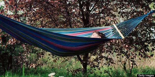 Boy napping outside in hammock