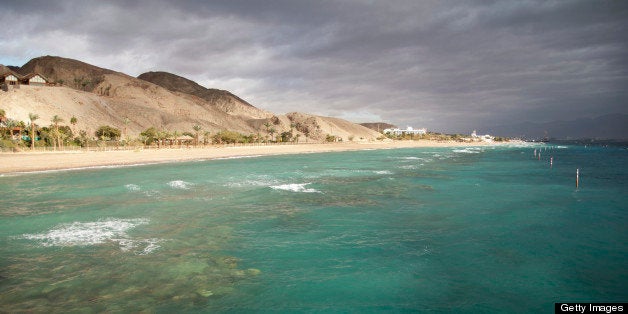 View of Eilat coastline with coral reef visible and dramatic sky