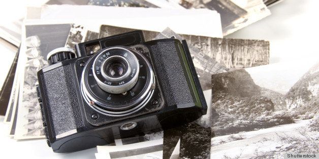 Old camera and pictures on a white background