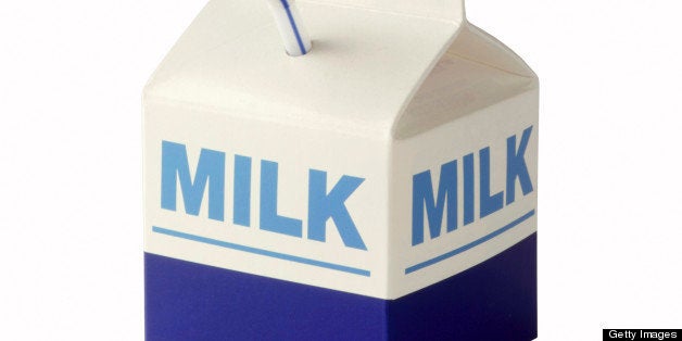 Milk carton with straw on white