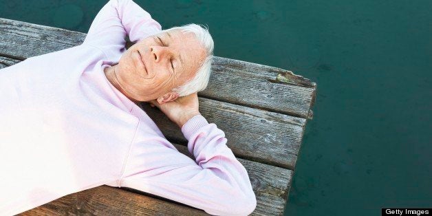 Senior man napping on jetty