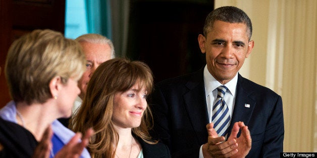 Katerina Rodgaard of Moms Demand Action for Gun Sense in America, center, prepares to introduce U.S. President Barack Obama during an event in the East Room of the White House in Washington, D.C., U.S., on Thursday, March 28, 2013. Obama, with families of victims of the Connecticut school shooting tragedy at his side, pressed the Senate to pass gun-control legislation next month and urged lawmakers to resist any weakening of resolve. Photographer: Joshua Roberts/Bloomberg via Getty Images 