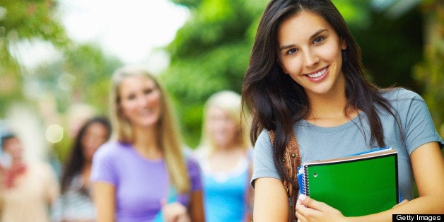 Beautiful, young woman standing in the campus and smiling'