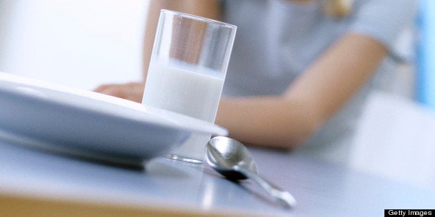 Teenage girl (13-14) in front of breakfast table