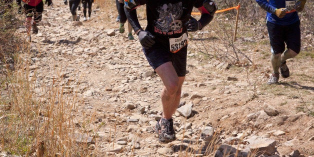 POCONO MANOR, PA - APR 28: Entrants face rocks on a steep incline for the Death March obstacle at Tough Mudder on April 28, 2012 in Pocono Manor, PA. The course is designed by British Special Forces.