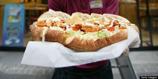 GERMANY - JULY 12: Employee of the US American sandwich fast-food chain Subway with a sandwich. (Photo by Ulrich Baumgarten via Getty Images)